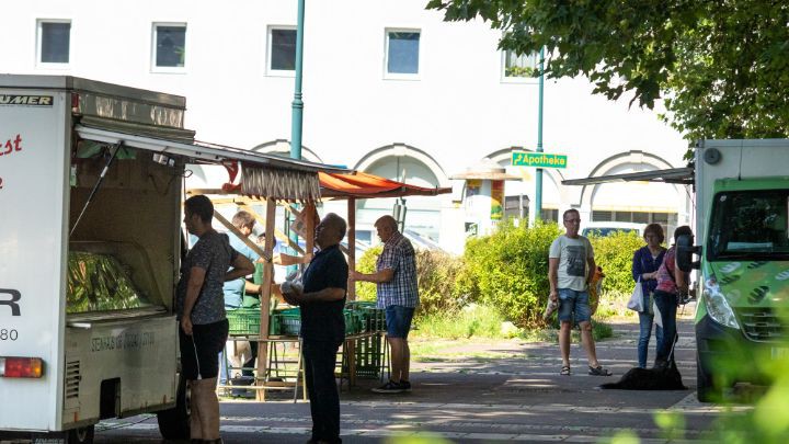 Kunden beim Warten vor den Marktständen